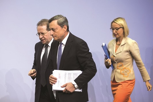 ECBu2019s president Mario Draghi (centre), vice-president Vitor Constancio and director-general for communications Christine Graeff depart following a news conference to announce the banku2019s interest rate decision at the ECB headquarters in Frankfurt yesterday. Draghi noted that growth and inflation were both moving along the path projected in June so more evidence, including fresh staff projections in September, were needed before any policy decision.