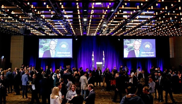 Screens display pictures of Australian Prime Minister Malcolm Turnbull