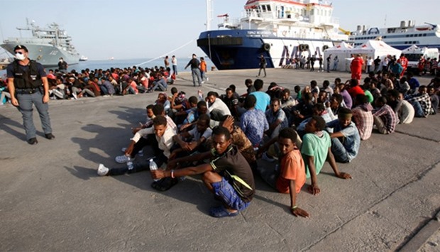 Migrants disembark from Migrant Offshore Aid Station ship