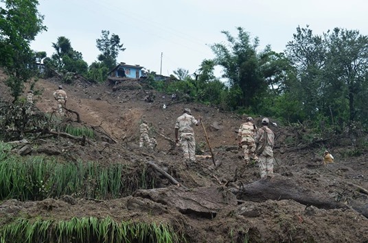 Soldiers search for survivors of a landslide following torrential rains in the Pithoragarh area of Uttarakhand yesterday.