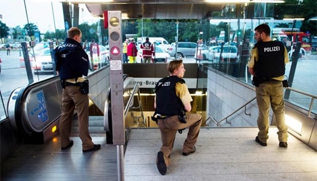 Police secure the entrance to a subway station near a shopping mall where a shooting took place in Munich on Friday.