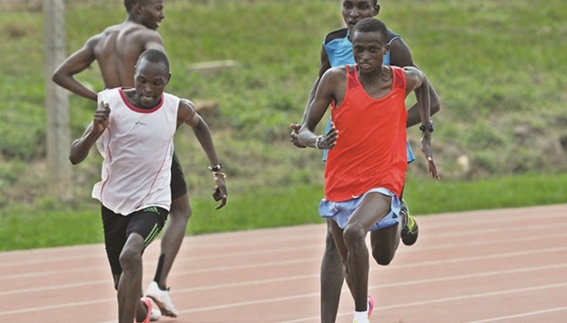 Kenyan long distance Paul Tanui (R) runs alongside his pace-setters at the high altitiude Kipchoge Keino stadium in Eldoret.