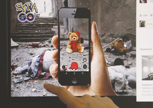 A journalist looks at a montage by a Syrian artist, using the international frenzy over the Pokemon Go game to draw new attention to the battle-scarred country, in Beirut yesterday.