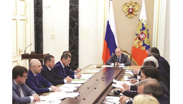 Russian President Vladimir Putin chairs a meeting with members of the government at the Kremlin in Moscow yesterday. President Vladimir Putin insisted Russia was committed to wiping out doping in a last-ditch push to avoid a possible blanket ban from the Rio Games over state-run dope cheating. The IOCu2019s executive board are to hold a conference call tomorrow to discuss barring Russia from the Rio Games that start on August 5