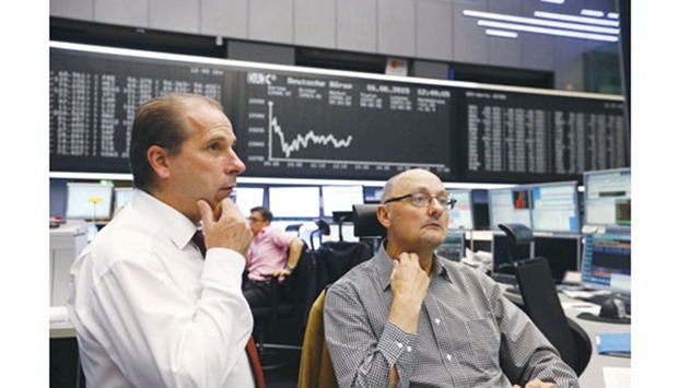 Traders talk in front of the German share price index board at the Frankfurt Stock Exchange. The DAX has rebounded 15% since its February low, more than the Stoxx Europe 600 Index.