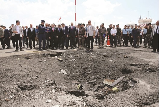 This handout picture taken and released by the Turkish prime ministeru2019s press office yesterday shows Prime Minister Yildirim and his aides visiting the Police Special Operation Departmentu2019s Headquarters in Golbasi district, Ankara. The 10-storey police headquarters, meant to be a symbol of might and order, is now a wreck, gutted by a successive air raids during the night of Turkeyu2019s failed coup. The coup plotters targeted above all key institutions in the capital including this police headquarters, the parliament and the presidency itself.