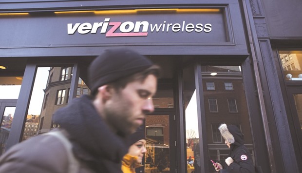 Pedestrians walk past a Verizon Communications shop in New York. Yahoo is focusing on Verizon  as the buyer of its core business after reviewing final bids that it received this week, people familiar with the matter said yesterday.