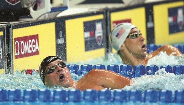 Michael Phelps (right) and Ryan Lochte react after the menu2019s 200 meter individual medley final in the US Olympic swimming team trials at CenturyLink Center in Omaha on Friday. At bottom, Phelps with his fiancee Nicole Johnson and son Boomer.
