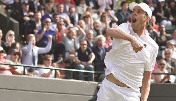 Sam Querrey of the US leaps in joy after knocking out World No. 1 Novak Djokovic of Serbia in the third round at Wimbledon  in London yesterday. (AFP)