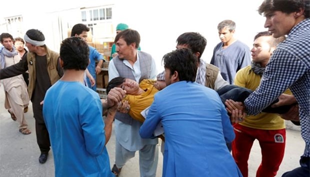 An injured person is carried to hospital after a suicide attack in Kabul on Saturday.