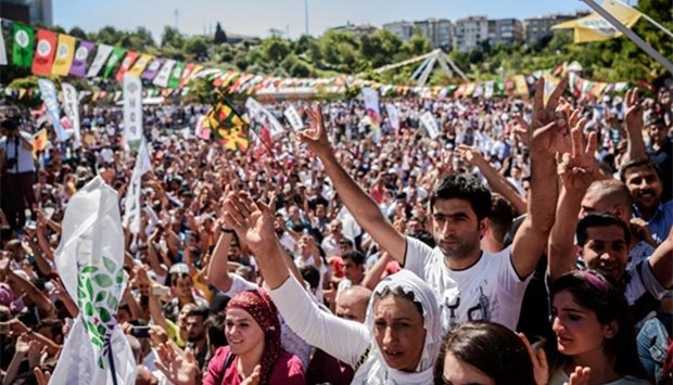 Pro-Kurdish supporters gather during a rally against military coup and the state of emergency, one week after a failed coup, at the Gazi district in Istanbul on Saturday.