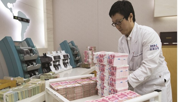 An employee arranges yuan banknotes at the Korea Exchange Bank headquarters in Seoul. The yuan advanced the most in two weeks, with the central banku2019s daily fixing adding to signs that Chinau2019s authorities are prepared to overrule the market to control the currencyu2019s moves.