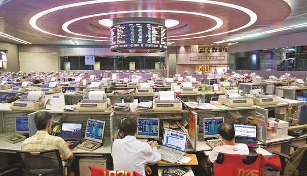 Traders work at the Hong Kong Stock Exchange. Bears are betting that Chinau2019s shift towards an economy driven by middle-class spending will leave some consumer stalwarts behind.