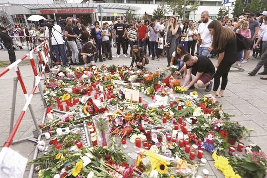 People lay flowers in front of Munichu2019s Olympia shopping mall, where Fridayu2019s shooting rampage started.