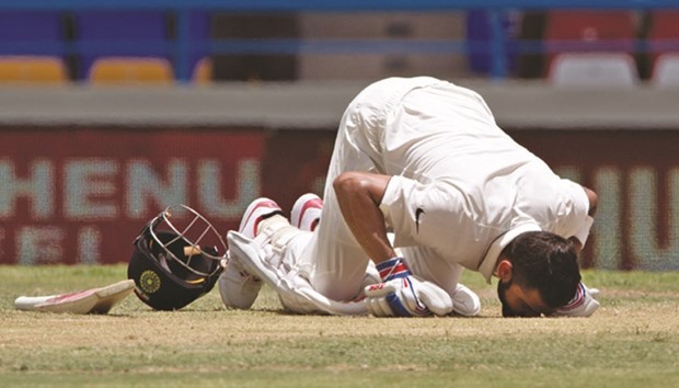 Virat Kohli kisses the pitch after reaching his 200 runs  against the West Indies.
