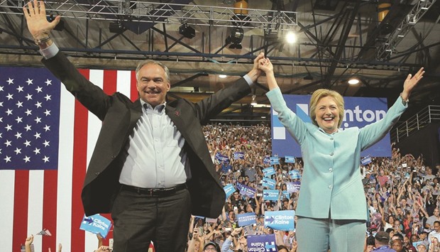 US Democratic presidential candidate Hillary Clinton and Democratic vice presidential candidate Senator Tim Kaine taking the stage at a campaign rally in Miami yesterday.