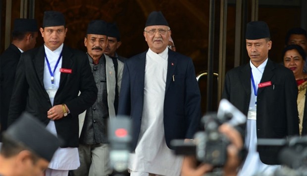 In this photograph taken on July 21, 2016, Nepalese Prime Minister KP Oli Sharma, (C) leaves the Parliament Building in Kathmandu.