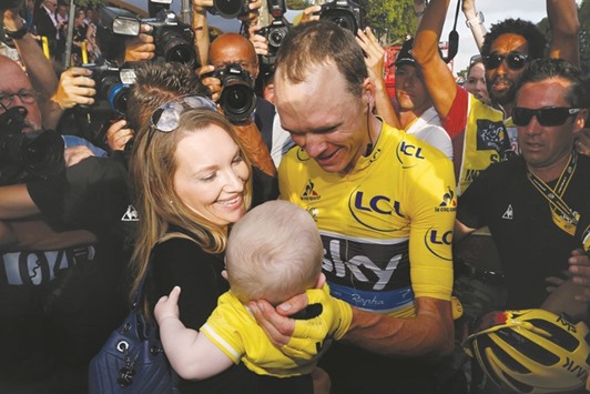 Team Sky rider Chris Froome of Britain celebrates with his wife Michelle Cound and their child after winning his third Tour de France title in Paris yesterday. (Reuters)