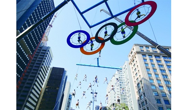 Acrobats perform on the Olympics rings at Paulista Avenue in Sao Paulou2019s financial centre yesterday.