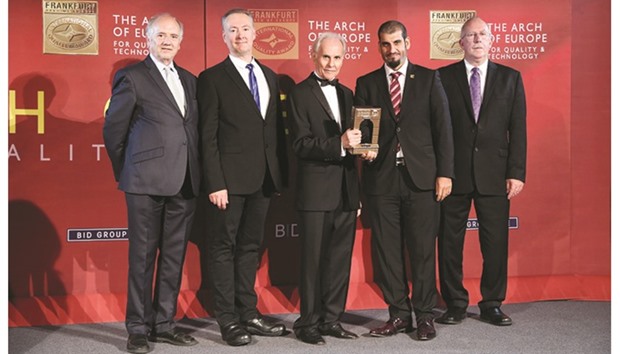Dignitaries from Qatar Finance and Business Academy receive an award in the Gold Category for u201cqualityu201d from Business Initiative Directions.