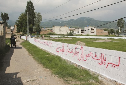 Pakistani workers mark the edges of the patch of ground where the house where Al Qaeda leader Osama bin Laden was killed once stood in Abbottabad on July 23.