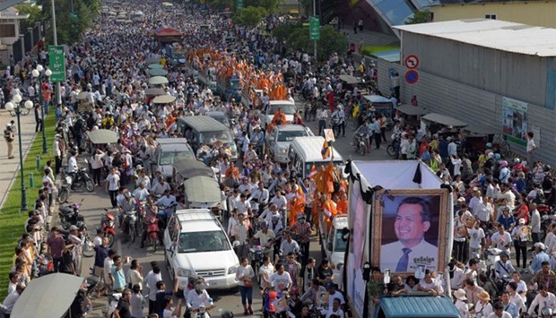 Thousands of people take part in a funeral procession for Kem Ley in Phnom Penh.
