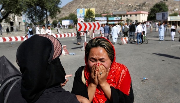 An Afghan woman weeps at the site of a suicide attack in Kabul, Afghanistan, on Saturday.