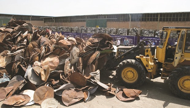 Satellite dishes and receivers being piled before being destroyed during a ceremony in Tehran. Iran destroyed 100,000 satellite dishes and receivers as part of a widespread crackdown against the illegal devices that authorities say are morally damaging.
