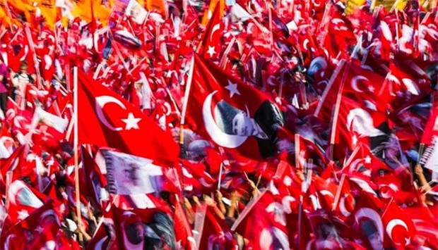 People wave Turkish flags during a rally organised by the main opposition group, Republican People's Party (CHO), in Istanbul's Taksim square on Sunday.