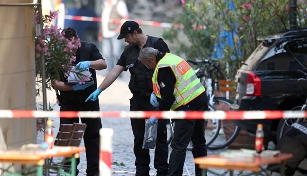 Police investigators work at the site of a suicide bombing in Ansbach, southern Germany. AFP