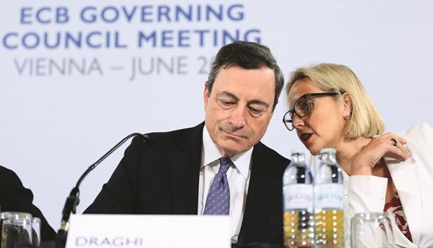 European Central Bank president Mario Draghi (left) listens as Christine Graeff, director-general for communications at the ECB, speaks during a news conference in Vienna. As ECB economists gather data for new forecasts for policymakersu2019 meeting in September, Draghi has said early estimates of the economic impact of Britainu2019s decision to leave the European Union need to be taken with a u201cgrain of caution.u201d