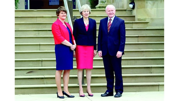 Prime Minister Theresa May poses for pictures with Northern Irelandu2019s First Minister Arlene Foster and Deputy First Minister Martin McGuinness as she arrives at Stormont Castle in Belfast, Northern Ireland, yesterday.