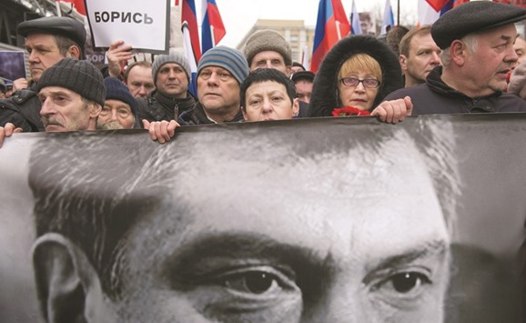 This file photo taken on March 1, 2015 shows Russiau2019s opposition supporters carrying a banner bearing a portrait of Kremlin critic Boris Nemtsov during a march in central Moscow.