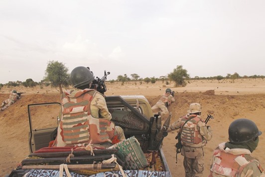 Niger soldiers guarding with their weapons pointed towards the border with neighbouring Nigeria, near the town of Diffa.