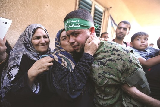 Freed Palestinian prisoner Mohamed al-Bashiti, who served 12 years in an Israeli jail after he was convicted of being a member of Hamasu2019 armed wing, is kissed by his aunt upon his release, in Rafah in the southern Gaza Strip, yesterday.