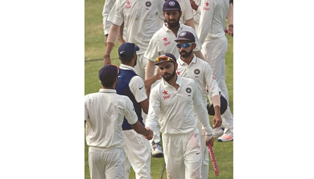Virat Kohli shakes hands with teammates after their win over the West Indies in St Johnu2019s, Antigua, on Sunday.