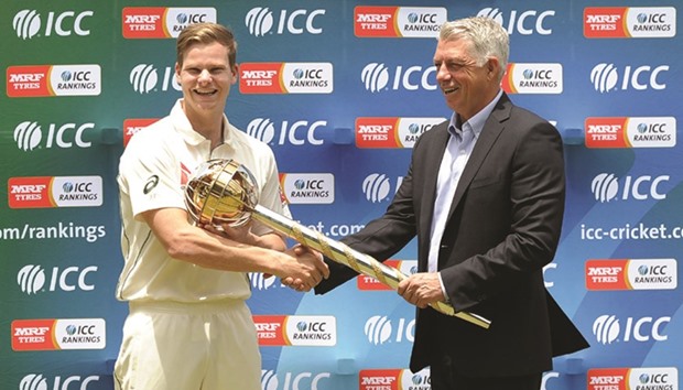 Australian cricket captain Steven Smith (L) receives an ICC Test Championship mace from ICC Chief Executive David Richardson (R) in Kandy yesterday.  Smith received the mace for leading his side to the number-one ranking on the MRF Tyres ICC Test Team Rankings on the annual 1 April cut-off date.