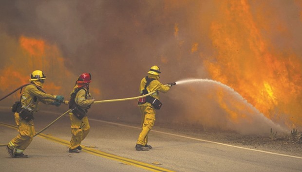 Firefighters battle flames in Placerita Canyon at the Sand Fire in Santa Clarita, California.