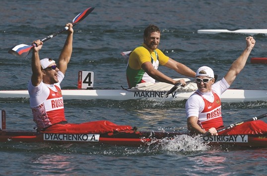 This file photo taken on August 11, 2012 shows Russiau2019s Yury Postrigay (right) and Alexander Dyachenko celebrating after winning the gold medal in the kayak double 200m menu2019s final during the London 2012 Olympics. Canoeingu2019s governing body has banned five Russians, including a gold medallist and a five-times world champion, from next monthu2019s Rio Olympics. The five were named as Elena Aniushina, Natalia Podolskaya, Alexander Dyachenko, Andrey Kraitor and Alexey Korovashkov. (AFP)