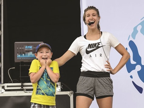 A young fan is excited to meet Eugenie Bouchard of Canada during the Rogers Cup in Montreal, Canada on Monday. (AFP)