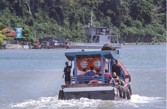 Family of death row prisoners ride a ferry boat to the prison island of Nusa Kambangan for a visit, in Cilacap, Central Java.