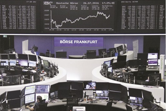 Traders work at the Frankfurt Stock Exchange. The bourse gained 0.5% yesterday.