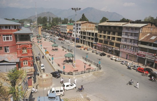 Motorists and pedestrians return to downtown Srinagar streets after authorities lifted a curfew in the city yesterday.