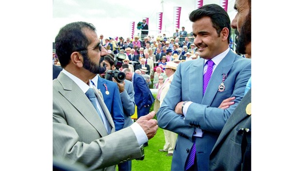 Ruler of Dubai Sheikh Mohamed bin Rashid al-Maktoum (left) and HE Sheikh Joaan bin Hamad al-Thani speak to each other on Day One of the Qatar Goodwood Festival yesterday.