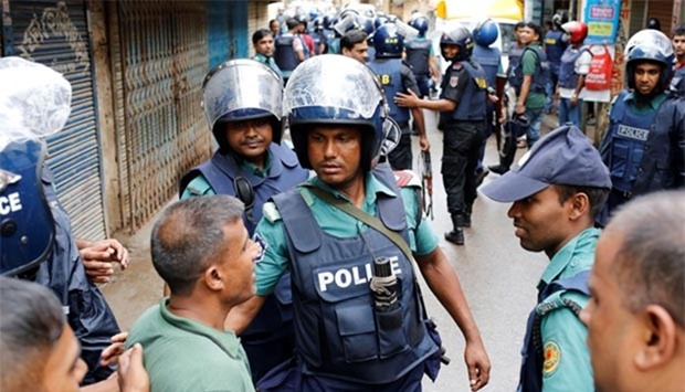 Police keep the public away near the site of a police operation on militants on the outskirts of Dhaka on Tuesday.