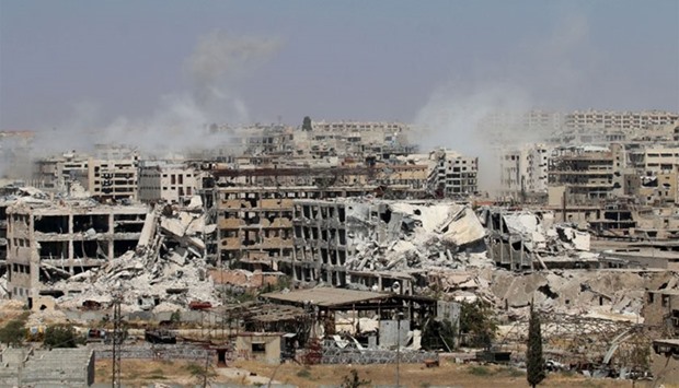 Smoke billows from buildings during an operation by Syrian government forces to retake control of the rebel-held district of Leramun, on the northwest outskirts of Aleppo.