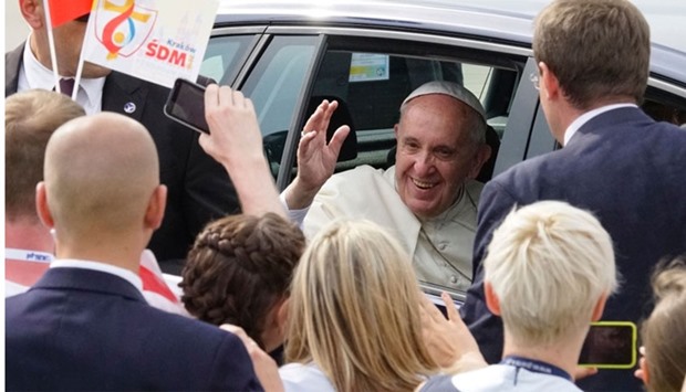 Pope Francis is greeted upon arrival at Balice military airport in Krakow.
