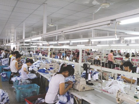 Workers at a garment factory in Shanghai. Chinau2019s official manufacturing Purchasing Managersu2019 Index (PMI) is expected to be 50.0 in July, the same as in June, according to the medium forecast of 23 analysts polled by Reuters.