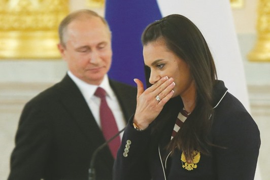 Track-and-field star Yelena Isinbayeva reacts as she walks past Russian President Vladimir Putin during his personal send-off for members of the Russian Olympic team at the Kremlin in Moscow yesterday. (Reuters)