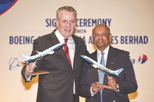 Malaysia Airlines chief executive officer Peter Bellew (left) and senior vice president of sales, Asia Pacific and India for Boeing, Dinesh Keskar, with replica models of the Boeing 737 Max aircraft after the signing ceremony in Putrajaya, outside Kuala Lumpur. Bellew said the airline was aiming to tap capital markets by March 2019.